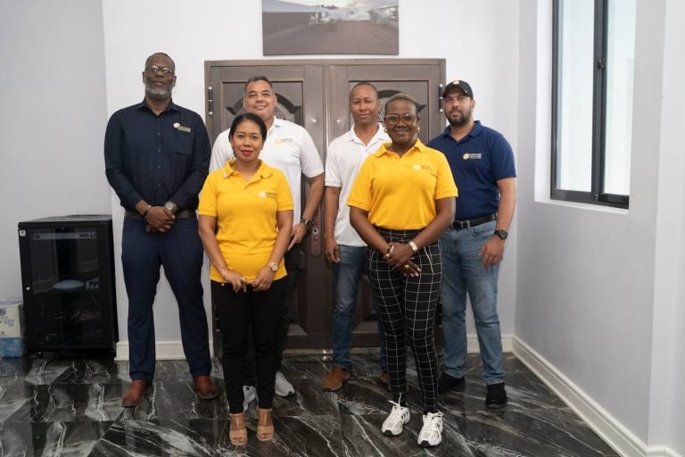 G Mining Ventures team members standing together for a group photo indoors at the Oko West project office.