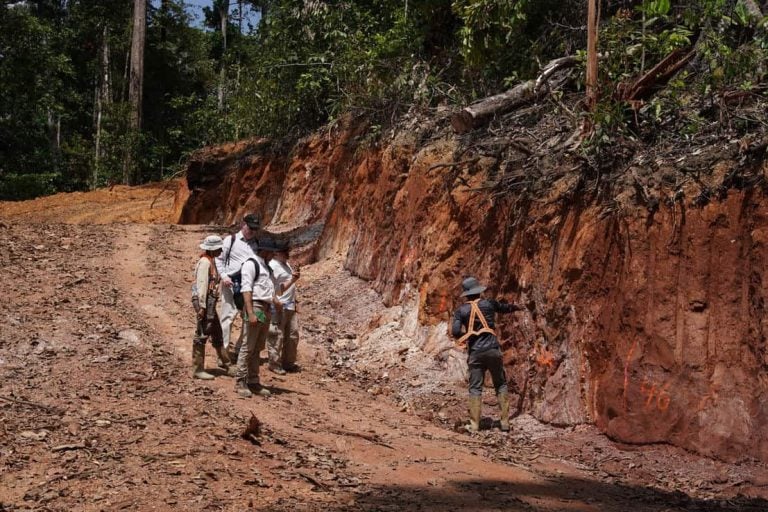 Field geologists conducting ground survey work in an excavated trench at a Greenheart Gold exploration site.