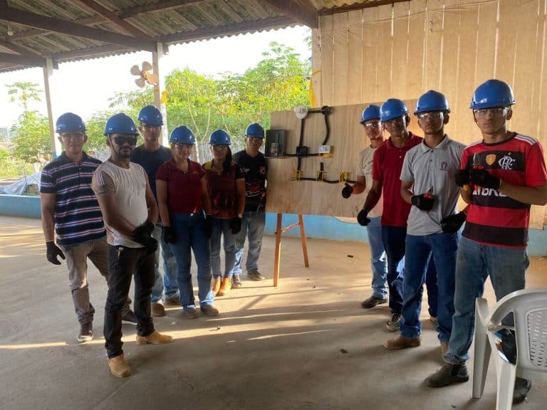 Workers wearing blue hard hats attending a vocational workshop at a Belo Sun Mining facility.