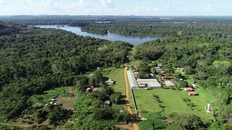 High-angle view of a river, airstrip, and dense forest near the Belo Sun Mining project region.