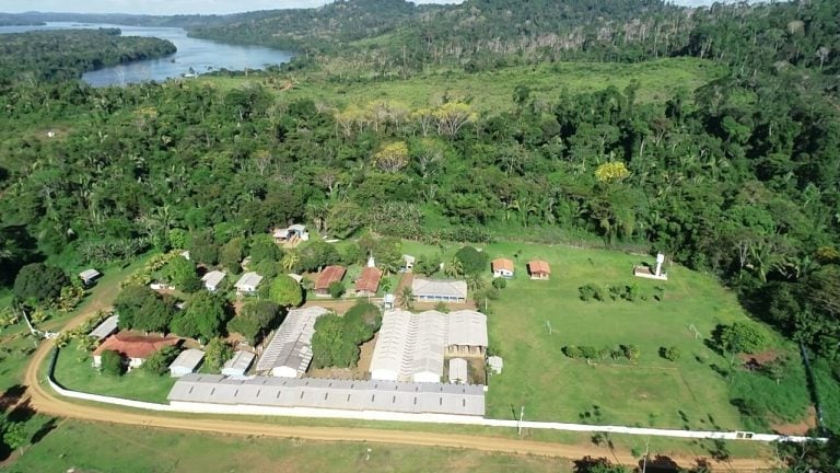 Aerial view of administrative and residential buildings surrounded by forest at the Belo Sun Mining site.
