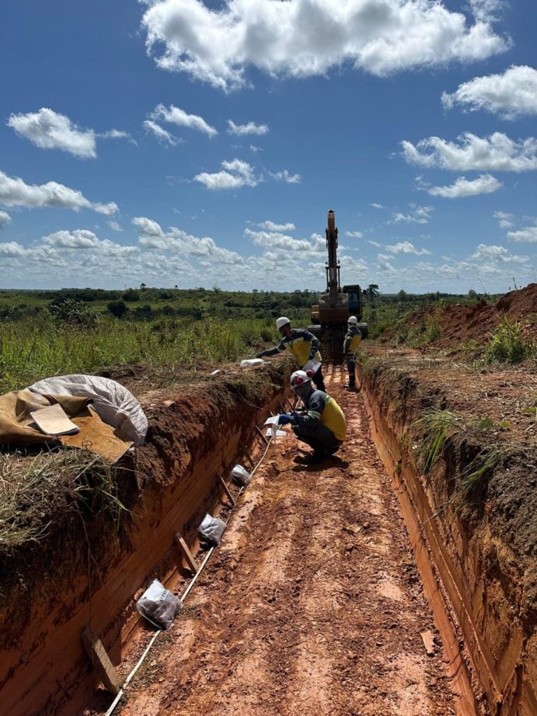 Endeavour Mining field workers collecting soil and trench samples along a greenstone belt gold exploration site in West Africa.