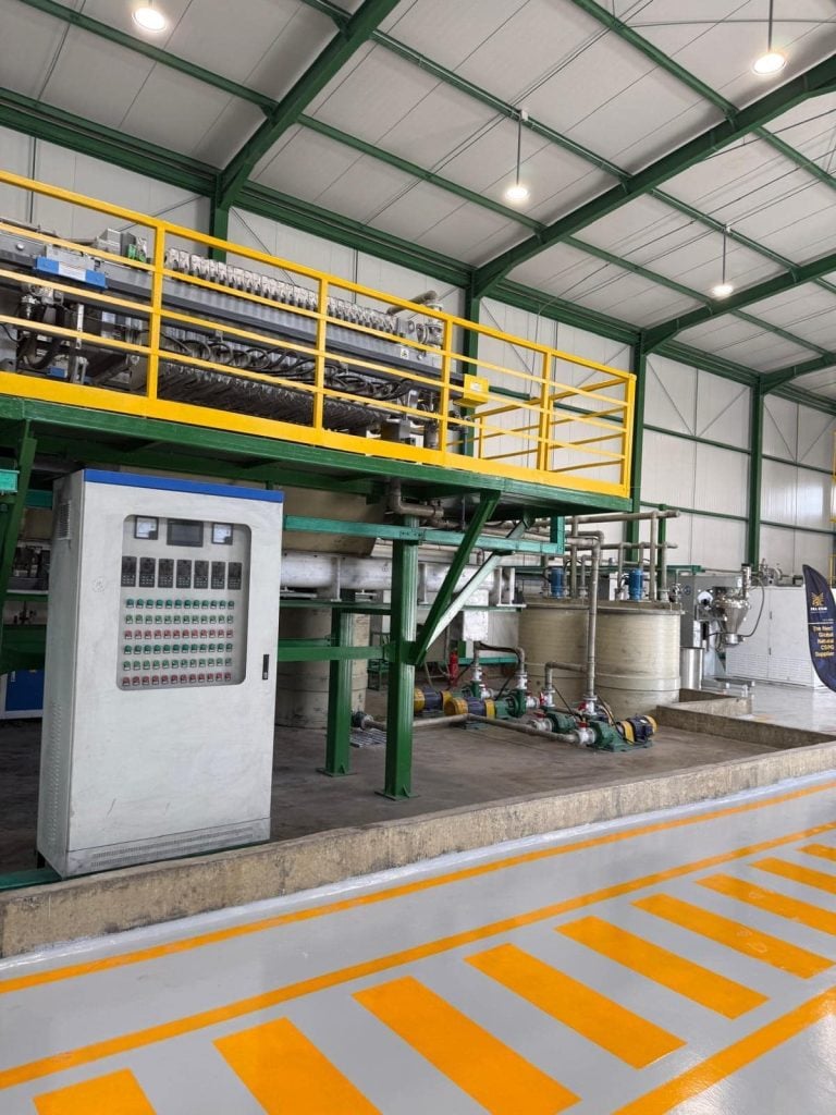Industrial processing equipment and control panels inside a Falcon Energy Materials chemical refining facility.