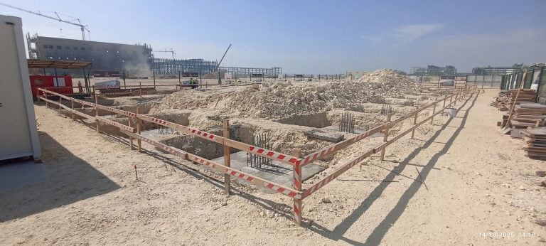 Excavation and foundation work encircled by safety tape at the construction site of the Falcon Energy Materials CSPG facility.